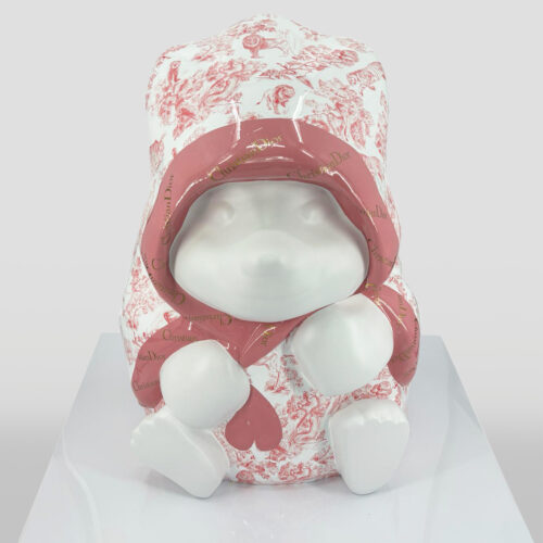 White bear sculpture wearing a pink and white hooded outfit with