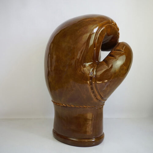 Large ceramic sculpture of a brown boxing glove.