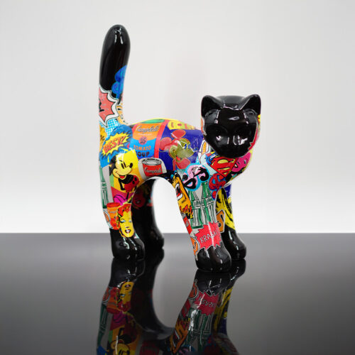 Painted ceramic cat with a colorful pop art design featuring various iconic images and logos, against a plain white background.