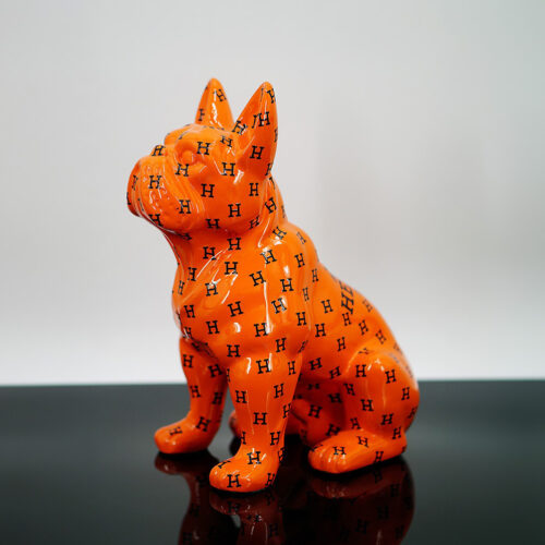 Orange ceramic statue of a French Bulldog with black 