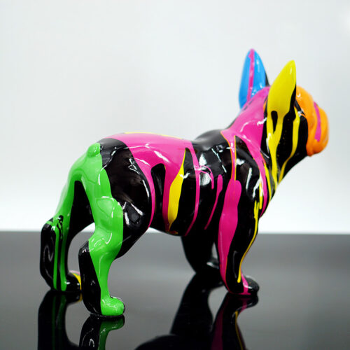 A colorful sculpture of a bulldog with a black base, covered in dripping bright green, pink, yellow, and blue paint.