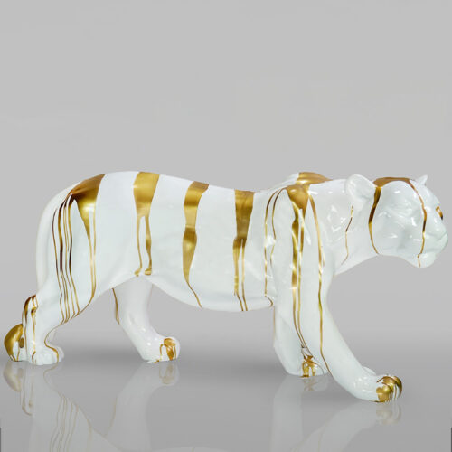White tiger sculpture with gold stripes.