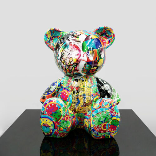 Colorful teddy bear sculpture covered in vibrant, eclectic designs, including faces, clocks, and abstract patterns, displayed on a black surface with a plain background.
