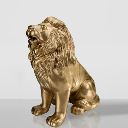Gold lion statue with a roaring expression, sitting on a reflective surface.
