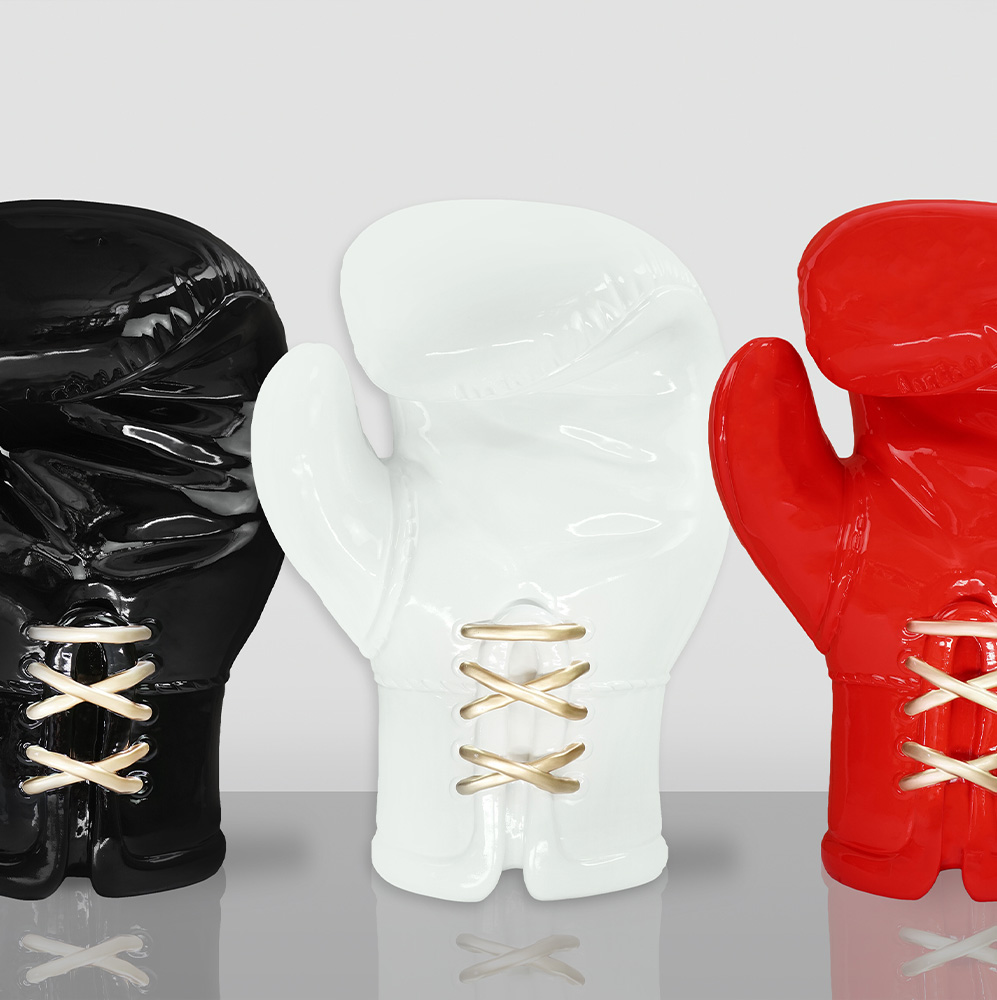 Large Realistic Boxing Glove Figure - White 3 Three ceramic sculptures of boxing gloves in black, white, and red, each with gold laces, displayed against a light gray background.