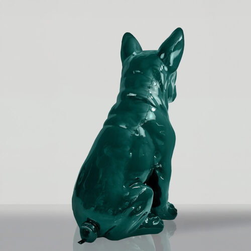 Green ceramic statue of a dog sitting and facing away.