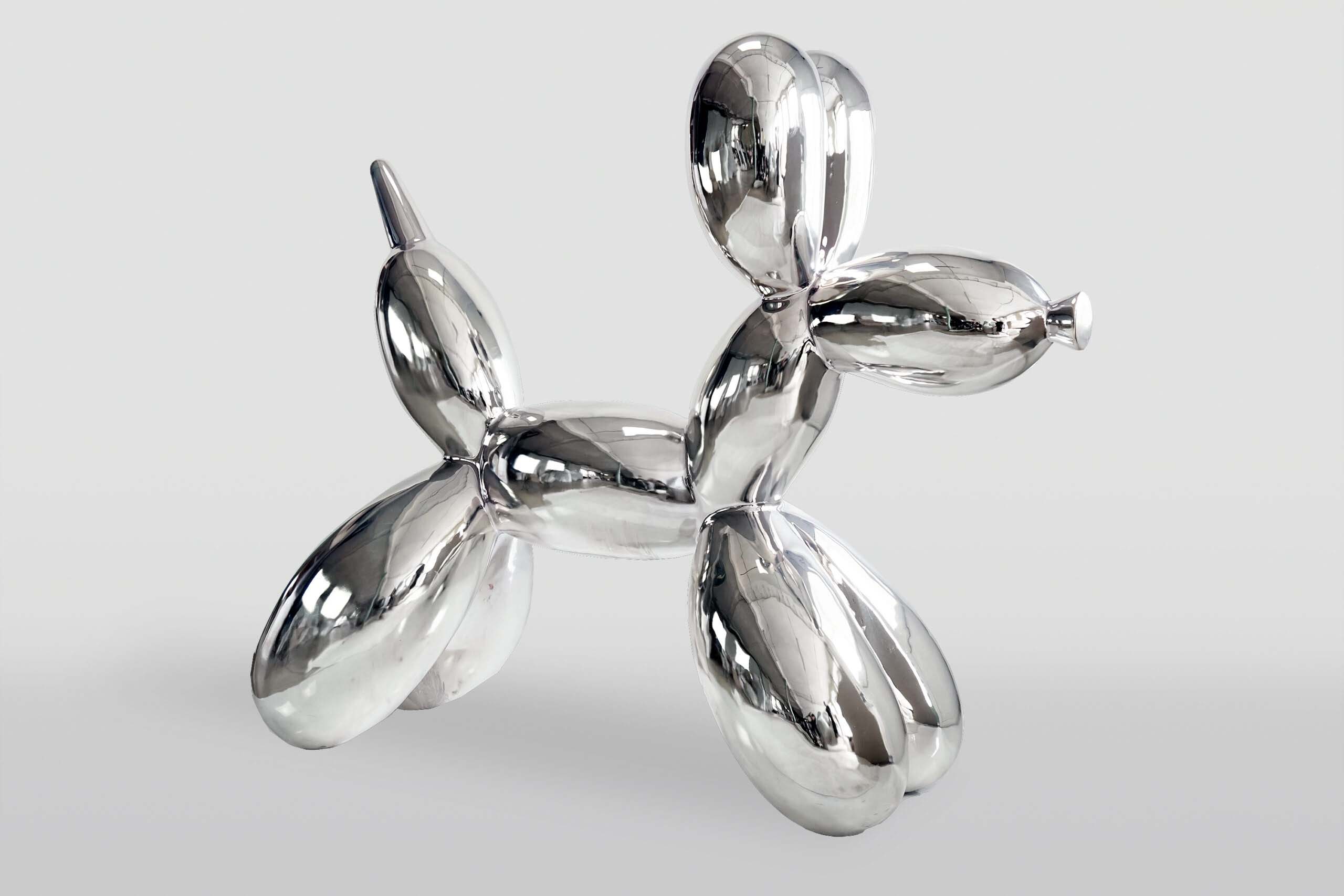 Metallic balloon dog sculpture on a light gray background.