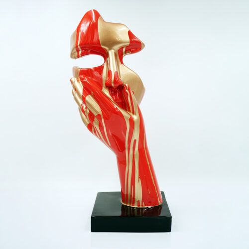 Black abstract sculpture of a hand covering a face mask.