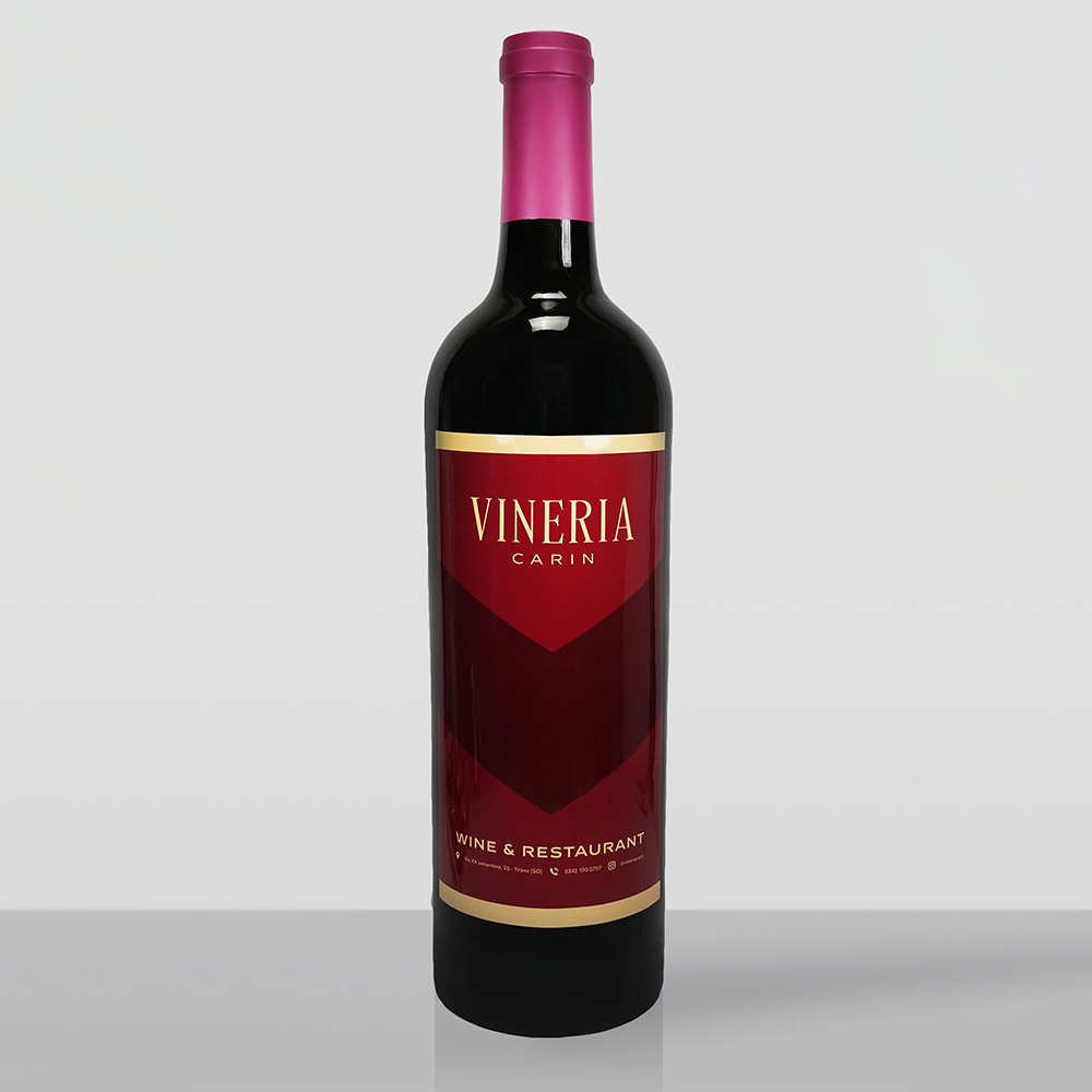 Classic XL Wine Bottle 3 A dark wine bottle with a red label and gold text that reads 'Vineria Carin' and 'Wine & Restaurant', set against a plain light gray background.
