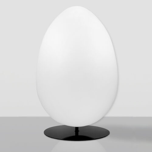 Smooth, large white egg-shaped object mounted on a flat, round black base, placed on a reflective grey surface against a light grey background.