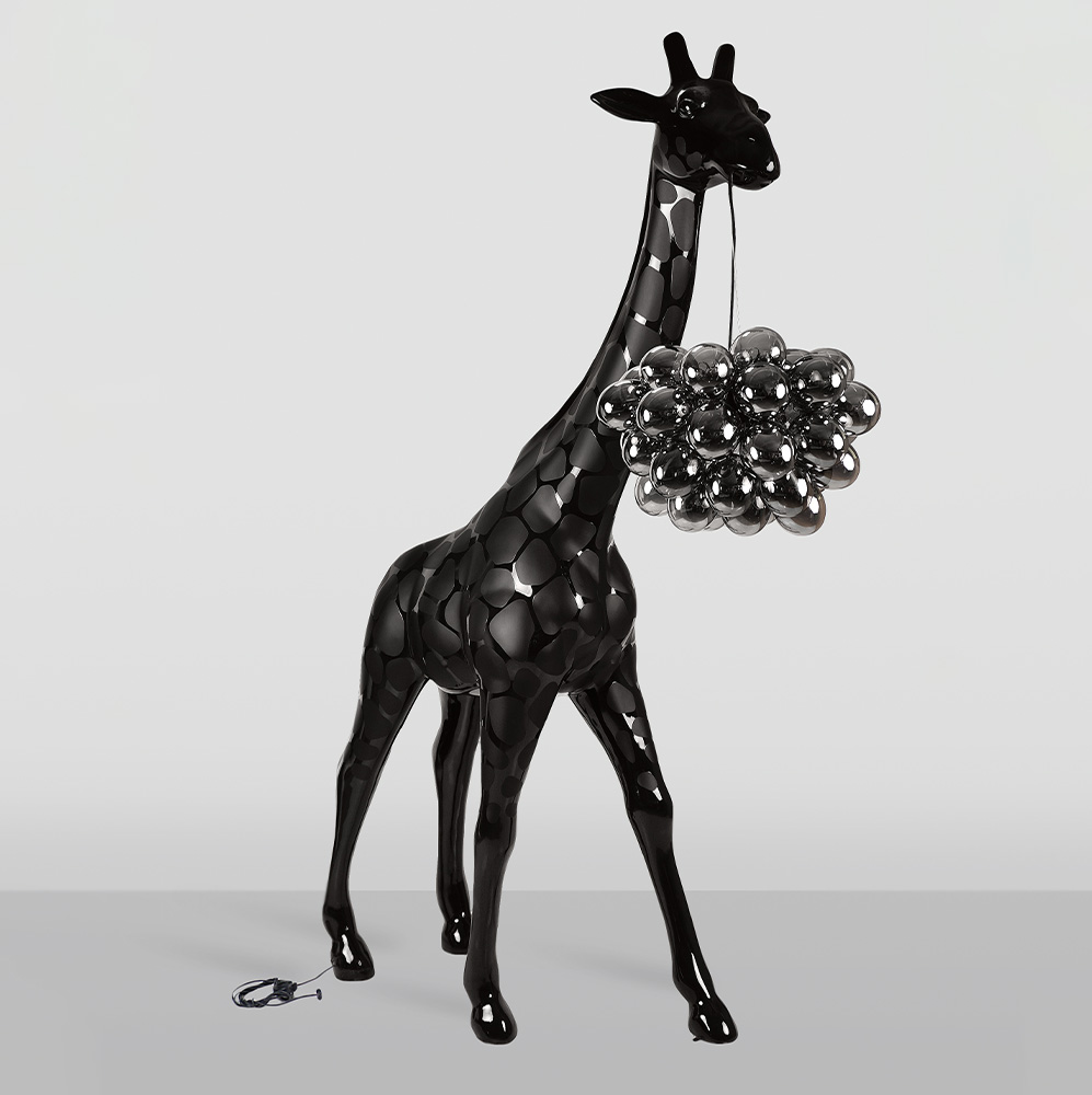 Large Giraffe 230cm Lamp – Black Version with Spots 2 Black glossy giraffe sculpture with a cluster of shiny black spherical shapes hanging from its mouth by a thin string, set against a plain light gray background.