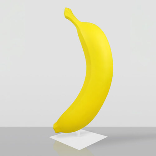 Bright yellow banana sculpture standing upright on a white square base against a plain light gray background