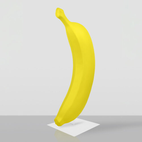 Bright yellow banana standing upright on a white square base against a plain light gray background.