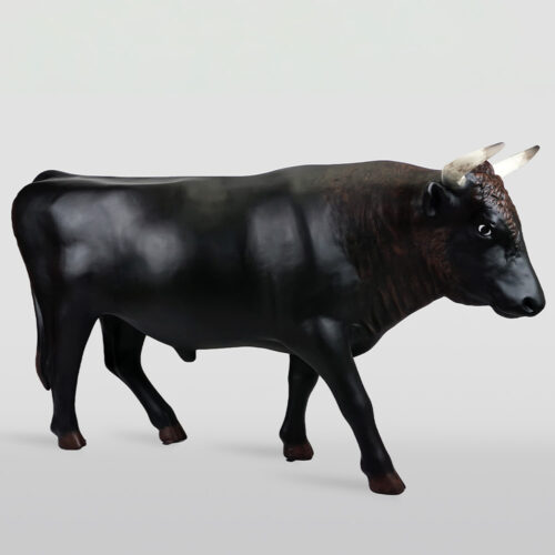 Realistic black bull sculpture with curved white horns on a plain light gray background.