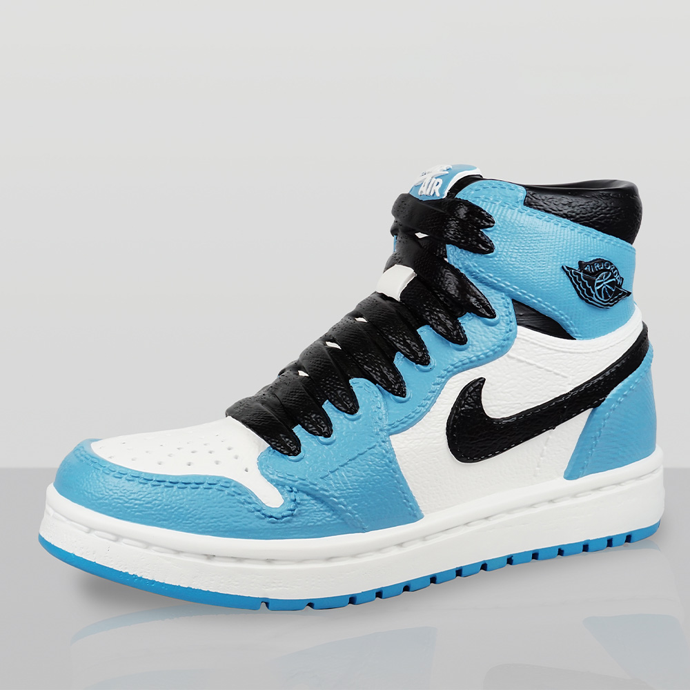 Decorative Figurine – Giant Nike Air Jordan I Shoe 1 High-top sneaker in white, light blue, and black with black laces, displaying the Nike Swoosh and Air Jordan wings logo on a reflective surface against a plain background.