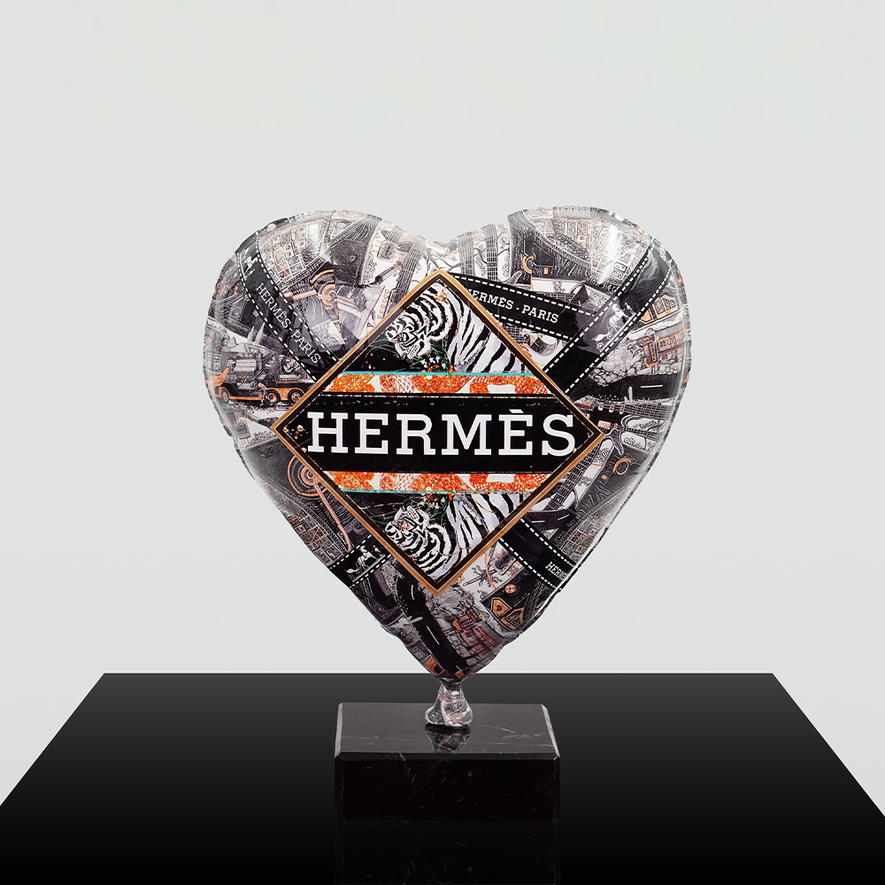 Decorative Heart-Shaped Balloon Figurine 13 Heart-shaped decorative balloon or sculpture with a collage of black and white images and the word