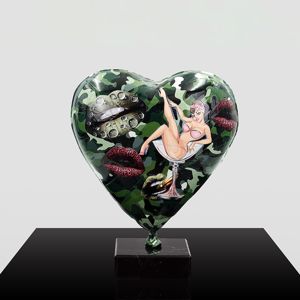 Decorative Heart-Shaped Balloon Figurine 8 Green camouflage heart-shaped balloon sculpture mounted on a black marble base, decorated with graphic images including lips, water droplets, and a pin-up style woman in a pink bikini lounging in a cocktail glass.