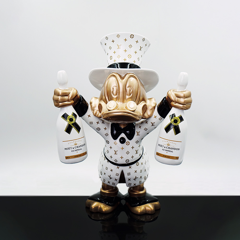 Decorative Figure – Mini Scrooge McDuck 2 A decorative figurine of a duck character dressed in a white and gold Louis Vuitton patterned outfit and top hat, holding two white Moët & Chandon Ice Imperial champagne bottles, standing on a reflective black surface against a plain white background.