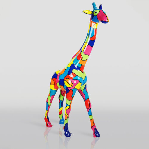Sculpture of a giraffe covered in a colorful patchwork pattern with bright shades of blue, pink, yellow, orange, green, and red standing on a reflective light gray surface.