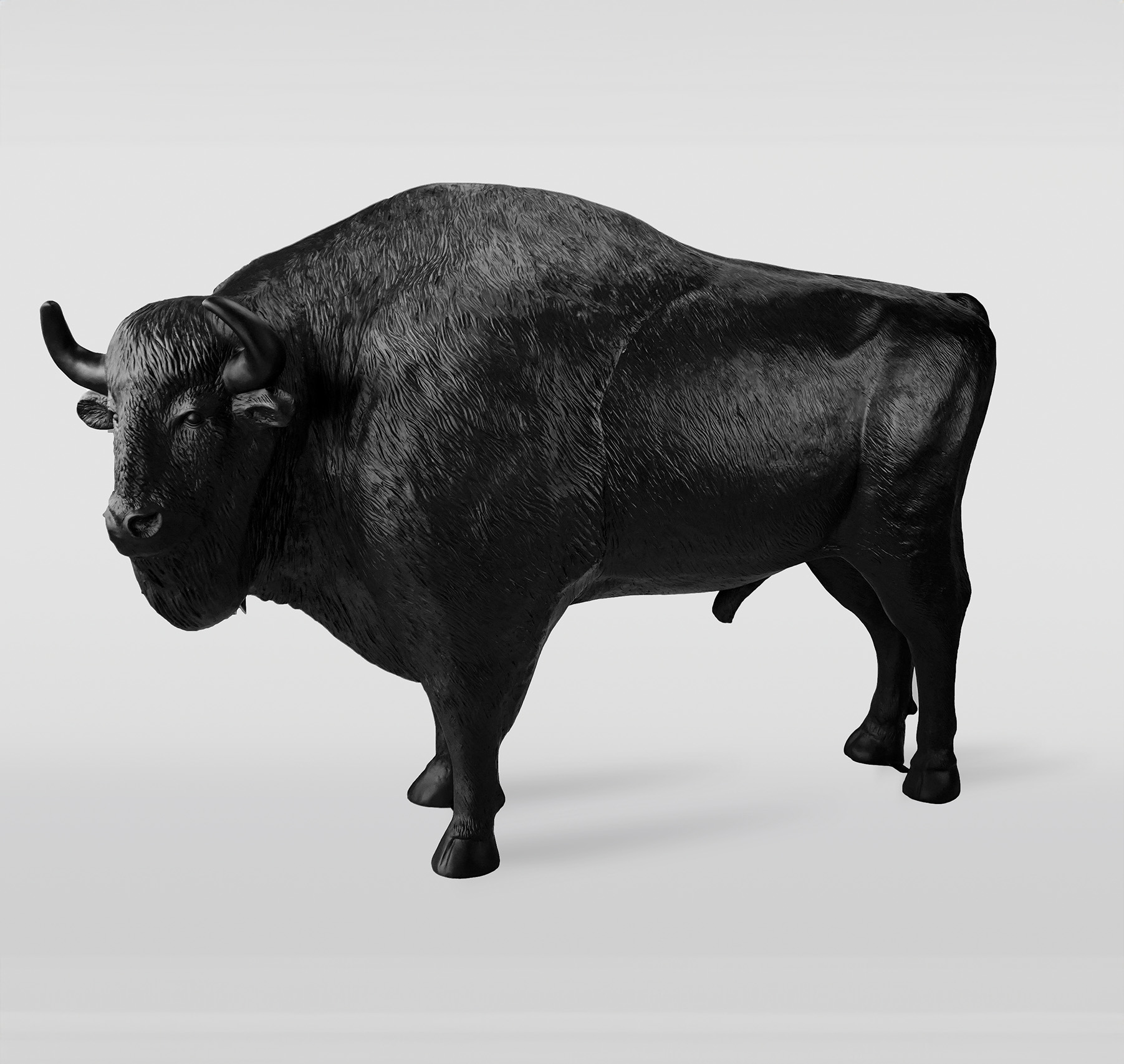 Czarno-biały realistyczny model bizona stojącego na neutralnym tle.