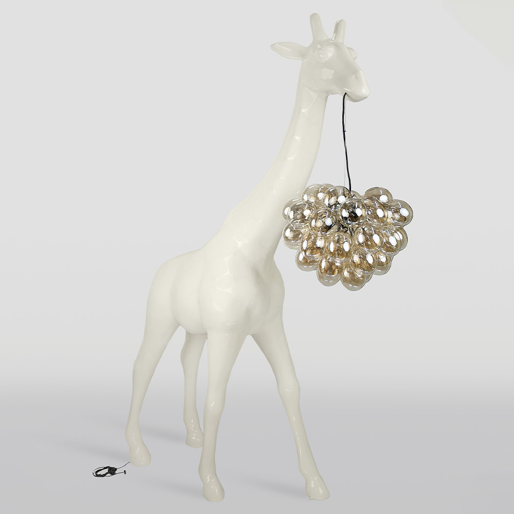 Large Giraffe 230cm Lamp – Beige Version with Spots 1 Tall white glossy giraffe sculpture with a cluster of transparent spherical lights hanging from its mouth by a black cord, against a plain light gray background.